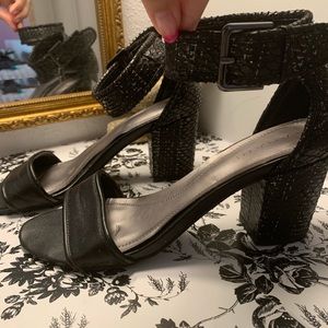 Black heeled sandal with ankle strap.